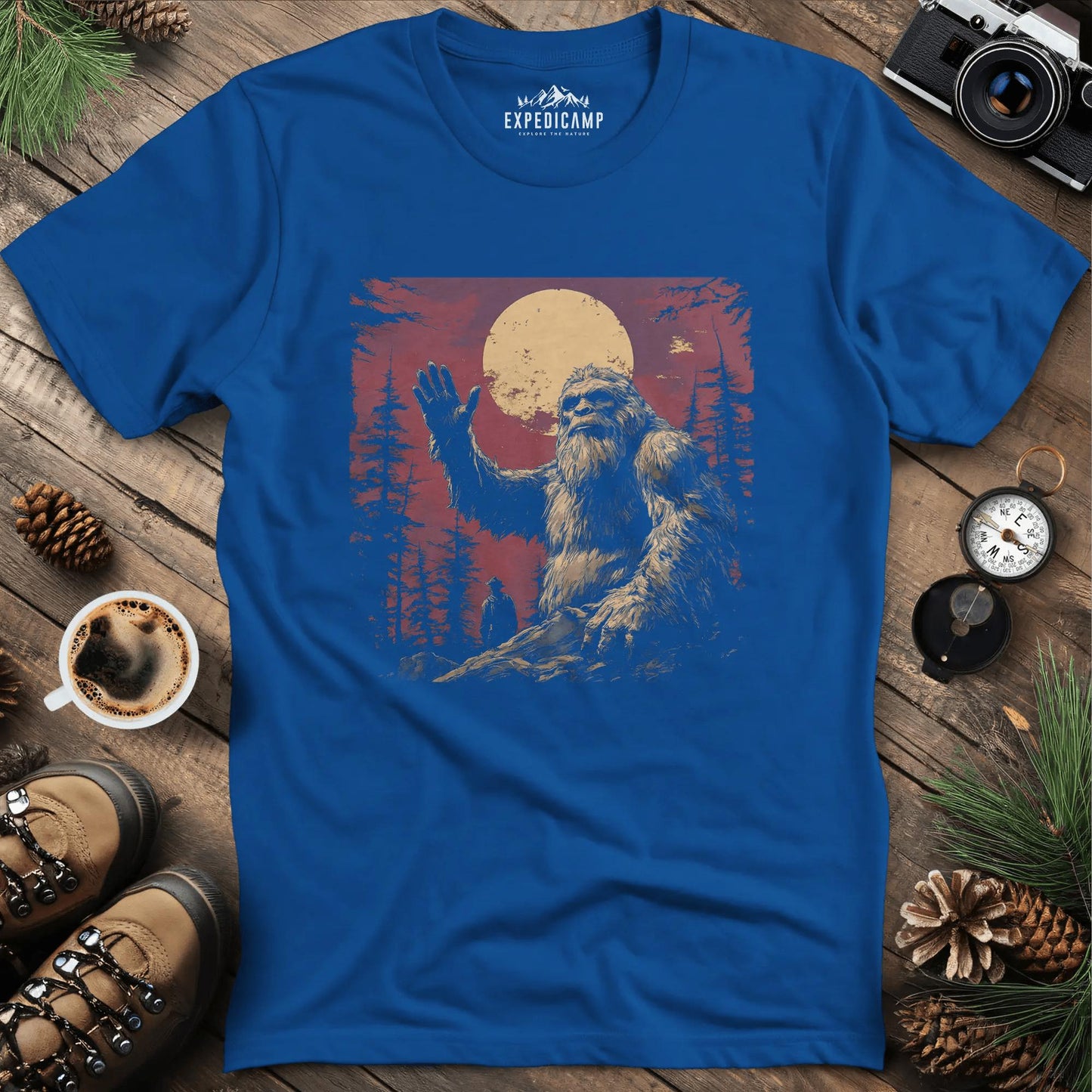 Bigfoot Waving T-Shirt – Friendly Sasquatch Under the Moon – Royal – Outdoor apparel for travel, hiking, camping, and nature lovers – ExpediCamp