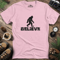 Believe Bigfoot T-Shirt – Light Pink – Outdoor apparel for travel, hiking, camping, and nature lovers – ExpediCamp