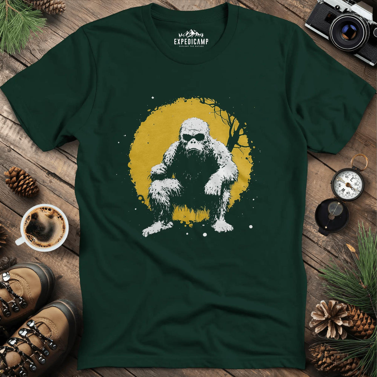 Bigfoot Swinging from a Tree T-Shirt – Adventurous Sasquatch Design – Forest Green – Outdoor apparel for travel, hiking, camping, and nature lovers – ExpediCamp