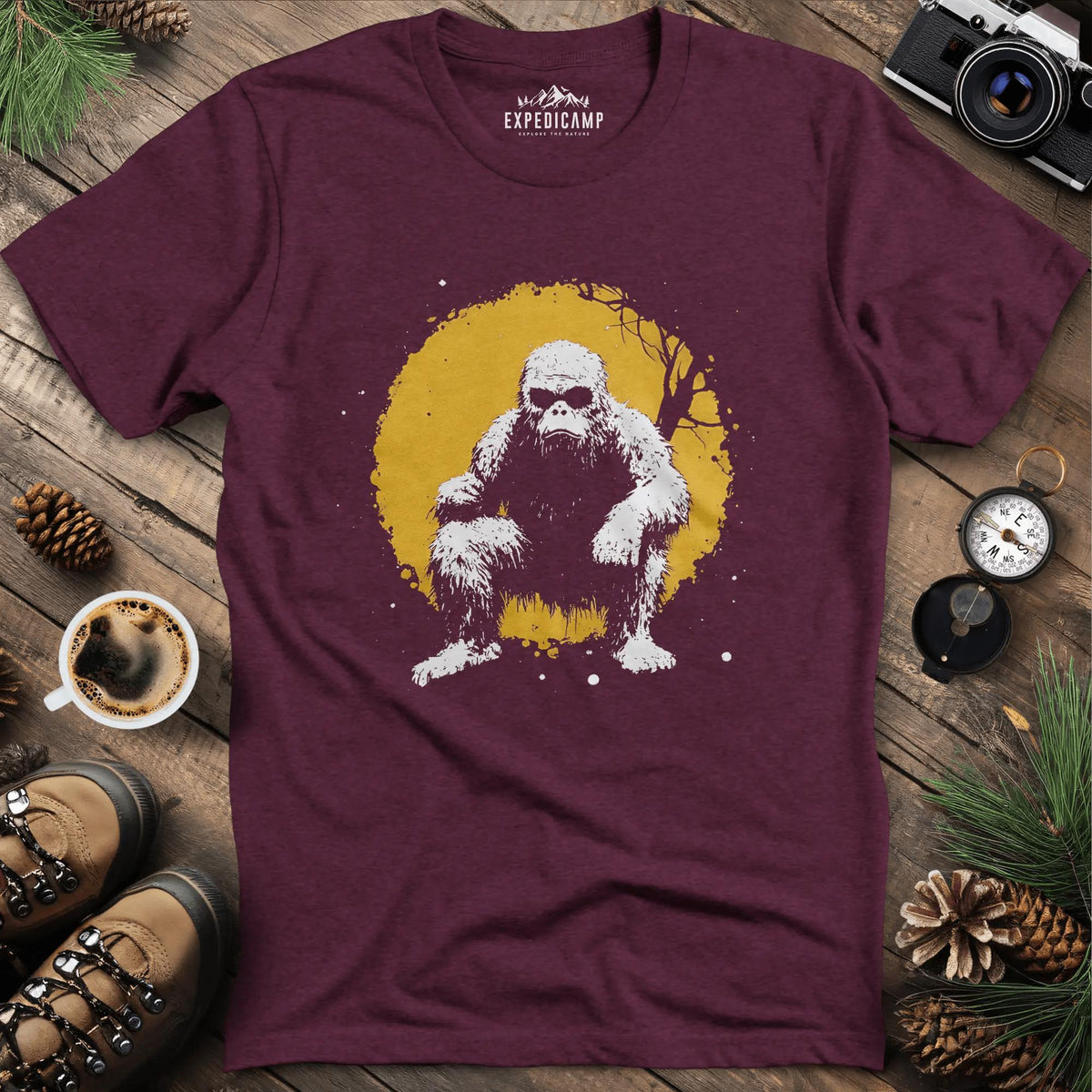 Bigfoot Swinging from a Tree T-Shirt – Adventurous Sasquatch Design – Heather Maroon – Outdoor apparel for travel, hiking, camping, and nature lovers – ExpediCamp
