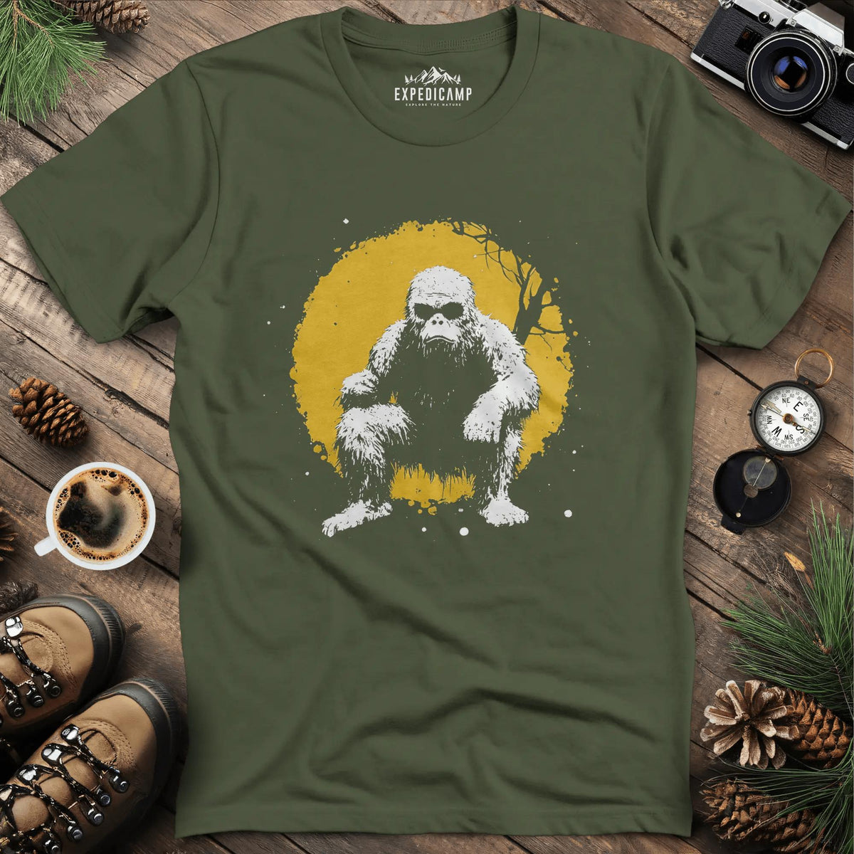 Bigfoot Swinging from a Tree T-Shirt – Adventurous Sasquatch Design – Military Green – Outdoor apparel for travel, hiking, camping, and nature lovers – ExpediCamp