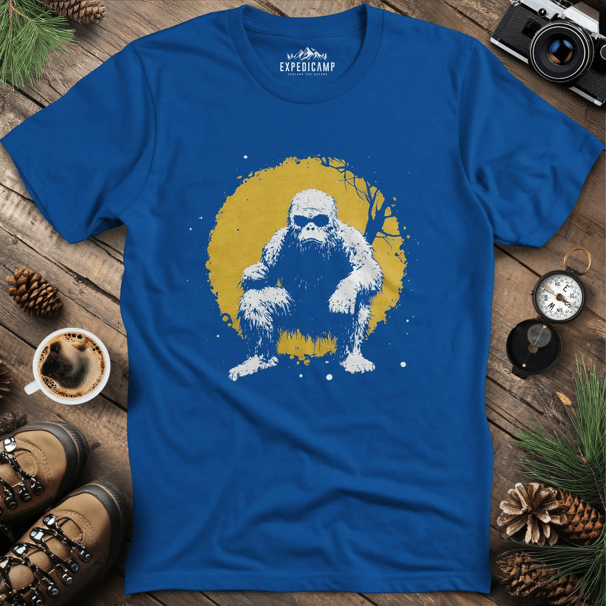 Bigfoot Swinging from a Tree T-Shirt – Adventurous Sasquatch Design – Royal – Outdoor apparel for travel, hiking, camping, and nature lovers – ExpediCamp