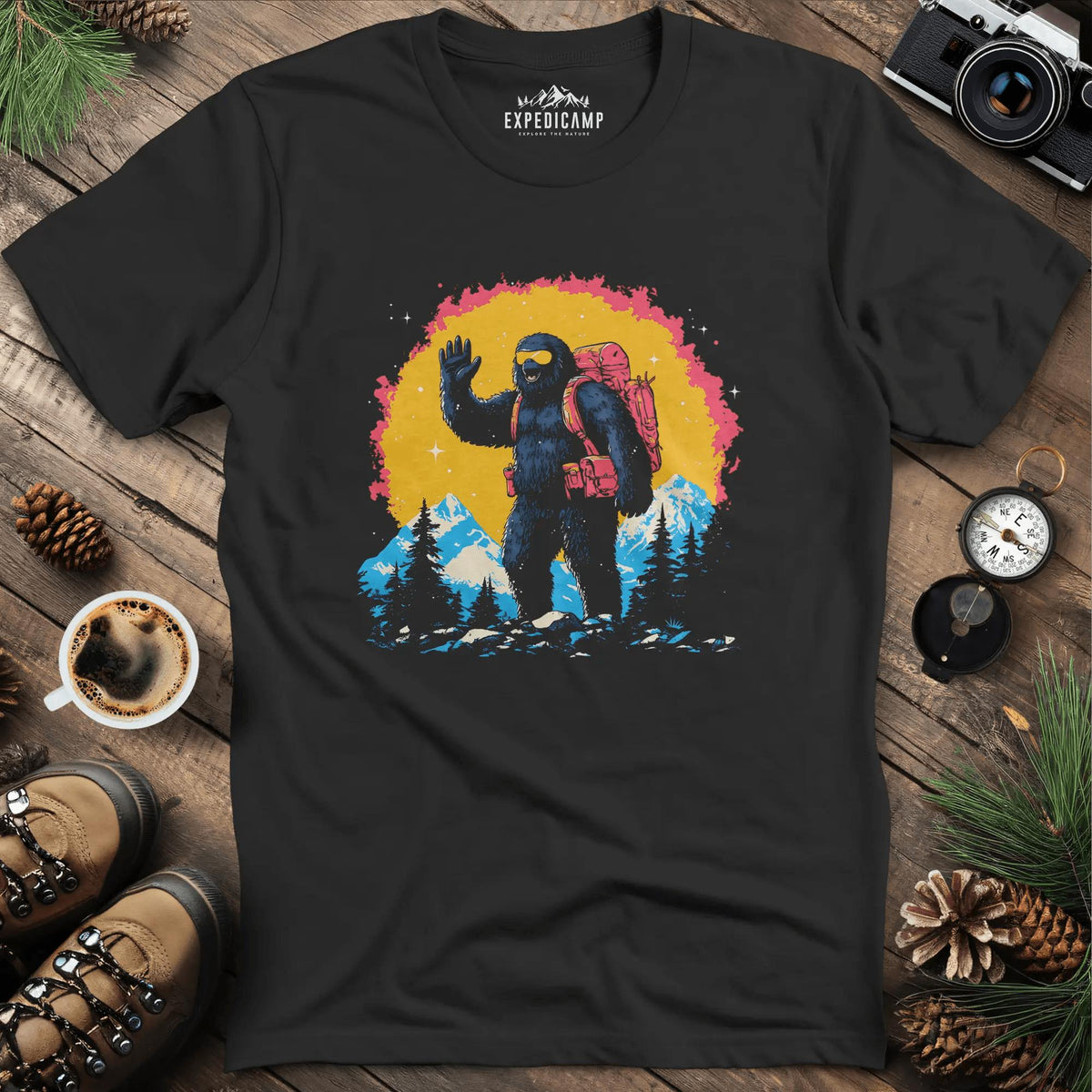 Bigfoot Waving T-Shirt – Friendly Sasquatch in the Mountains – Black – Outdoor apparel for travel, hiking, camping, and nature lovers – ExpediCamp