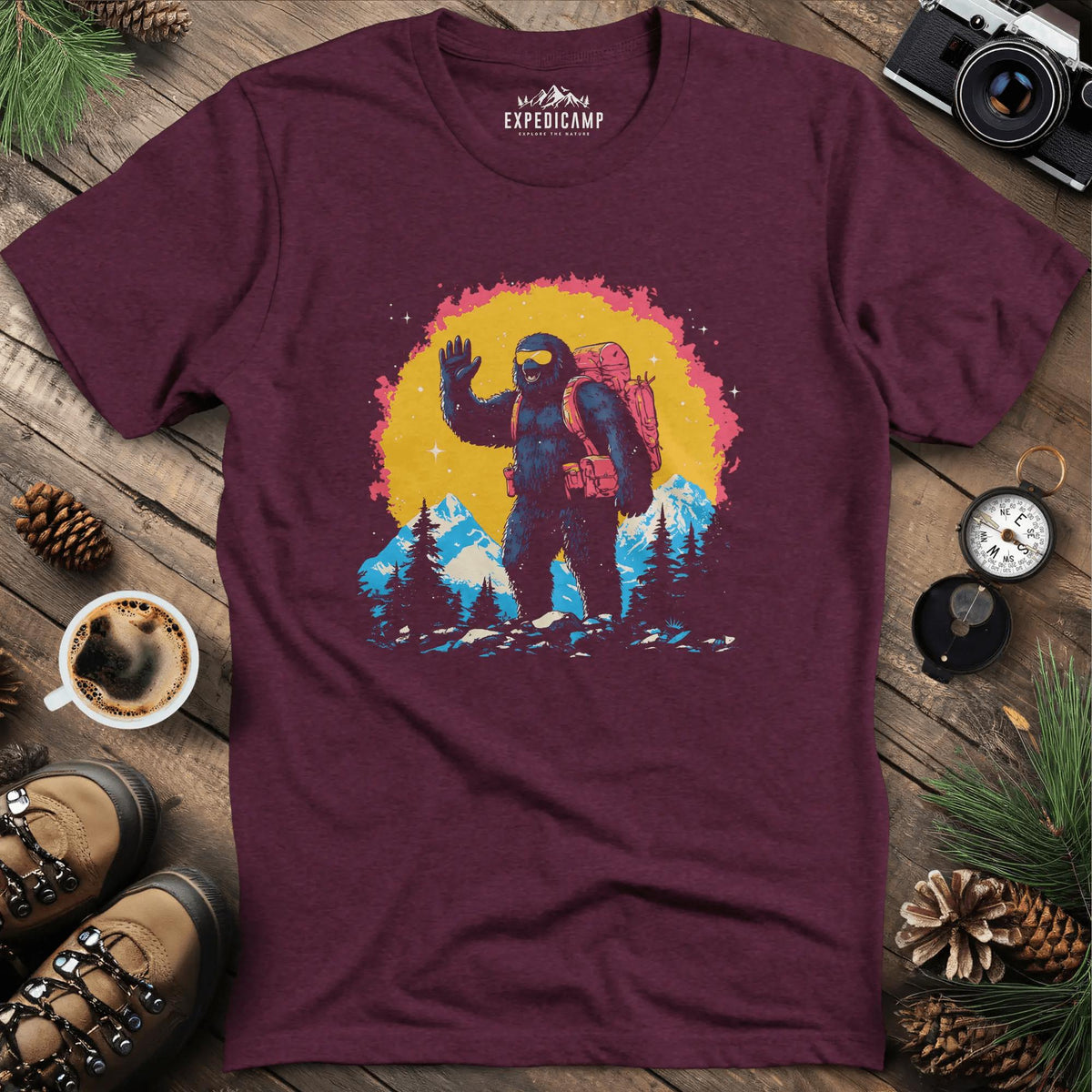 Bigfoot Waving T-Shirt – Friendly Sasquatch in the Mountains – Heather Maroon – Outdoor apparel for travel, hiking, camping, and nature lovers – ExpediCamp