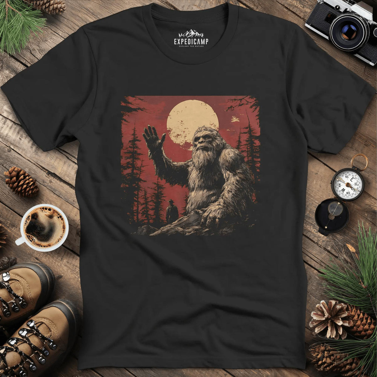 Bigfoot Waving T-Shirt – Friendly Sasquatch Under the Moon – Black – Outdoor apparel for travel, hiking, camping, and nature lovers – ExpediCamp