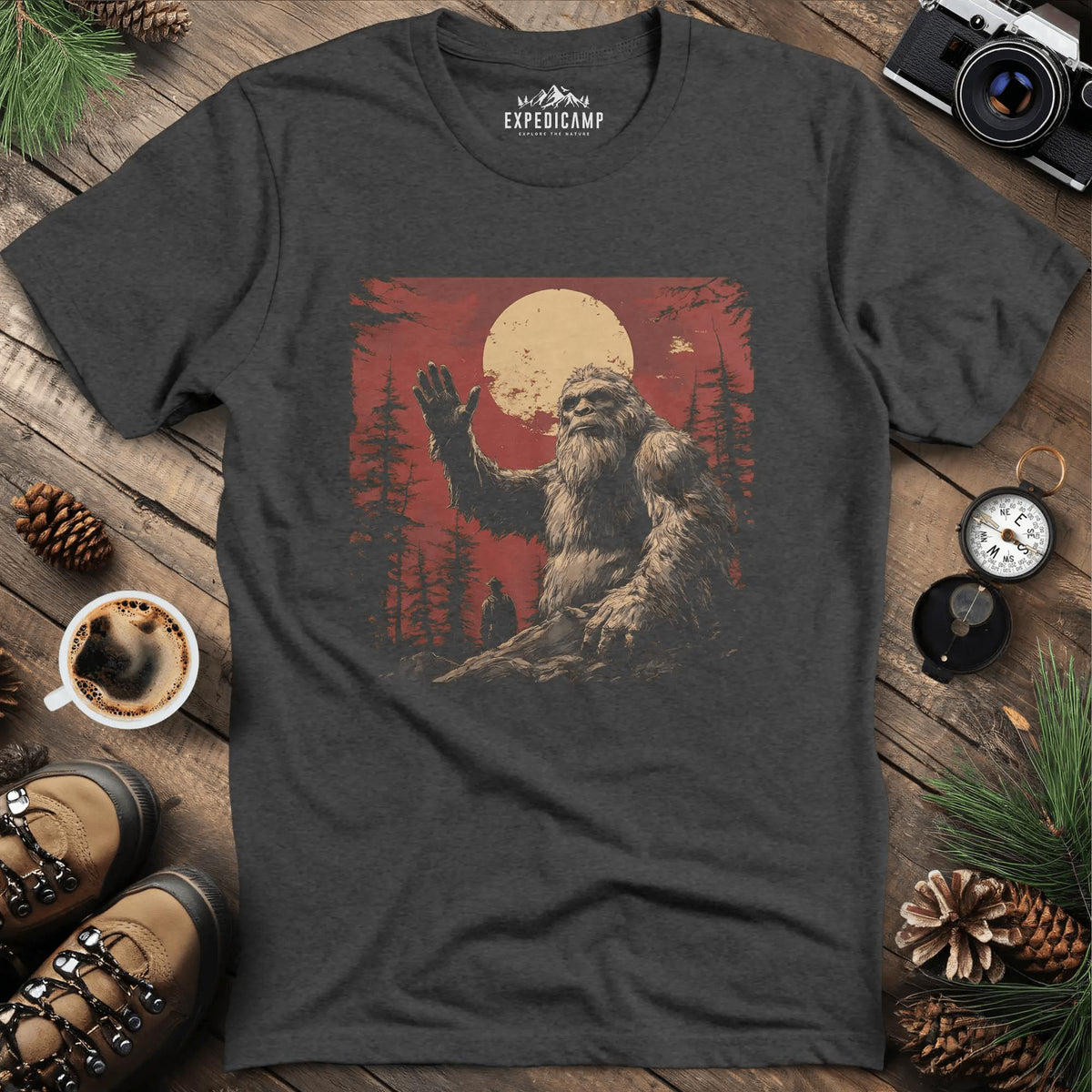 Bigfoot Waving T-Shirt – Friendly Sasquatch Under the Moon – Dark Heather – Outdoor apparel for travel, hiking, camping, and nature lovers – ExpediCamp