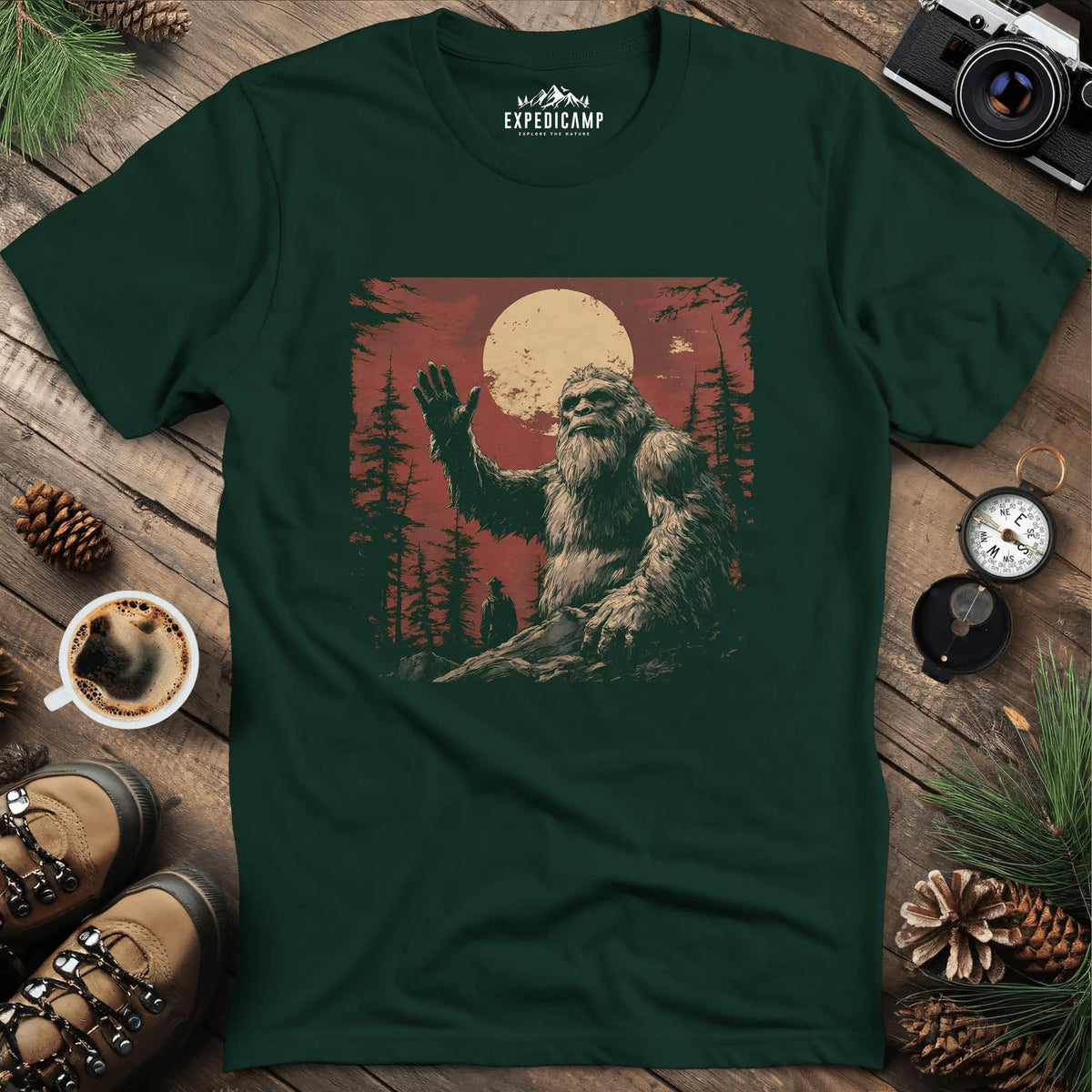 Bigfoot Waving T-Shirt – Friendly Sasquatch Under the Moon – Forest Green – Outdoor apparel for travel, hiking, camping, and nature lovers – ExpediCamp